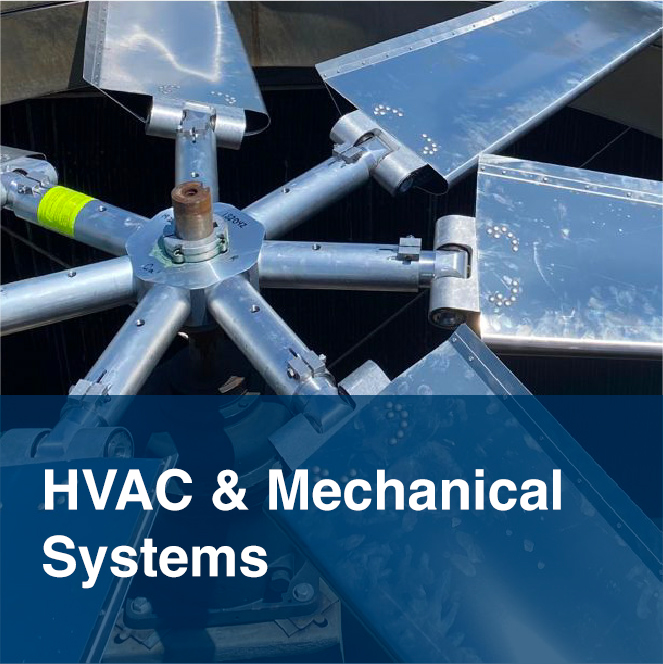 Close-up of large industrial fan blades used in an HVAC cooling system, representing commercial heating, ventilation, and mechanical services