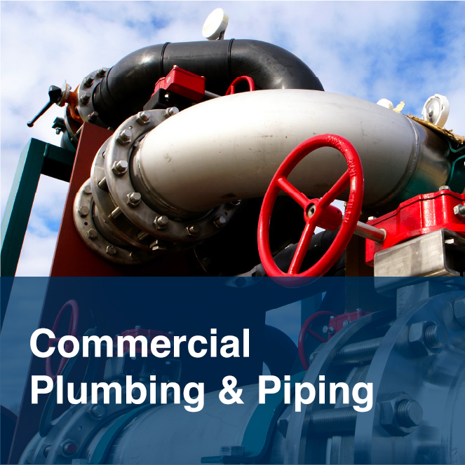 Industrial piping system with red and black valves and metal fittings, illustrating large-scale commercial plumbing and piping services.